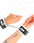 KINK - POLSO NERO CON PIZZO DECORATO BIANCO REGOLABILE 20 - 23 CM X 5,5 CM - KINK WRIST RESTRAINT - Intimo per le occasioni speciali | The Game Lingerie