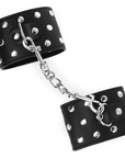 KINK - RESISTENZA DA POLSO CON CHIUSURA A SCATTO COMPLETA DI RIVETTI NERA REGOLABILE 19 - 24 CM X 5,5 CM - KINK WRIST RESTRAINT - Intimo per le occasioni speciali | The Game Lingerie